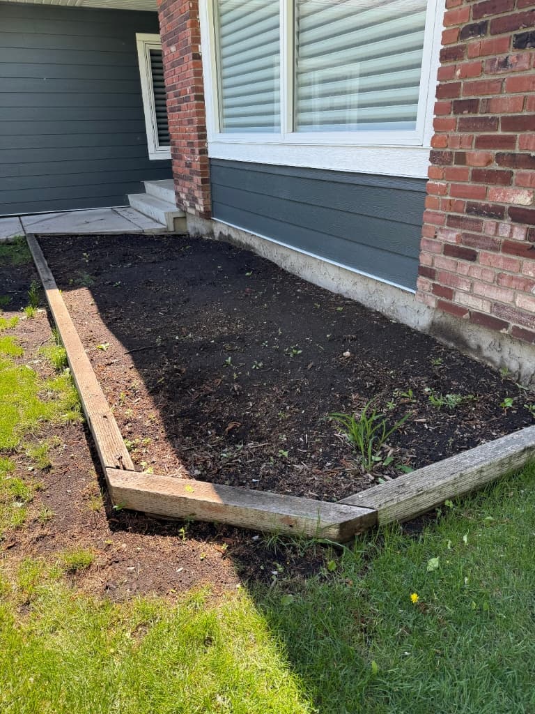 Finished rock bed with plants and river rock